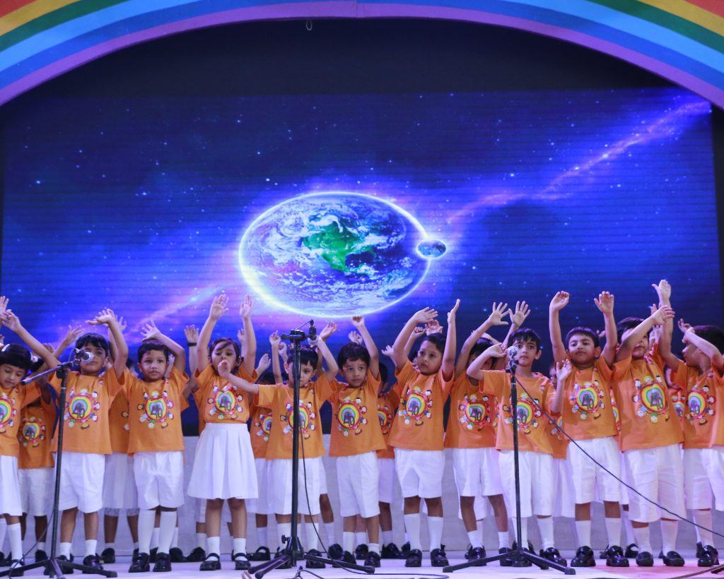 Junior school pupils singing on stage at Playpen