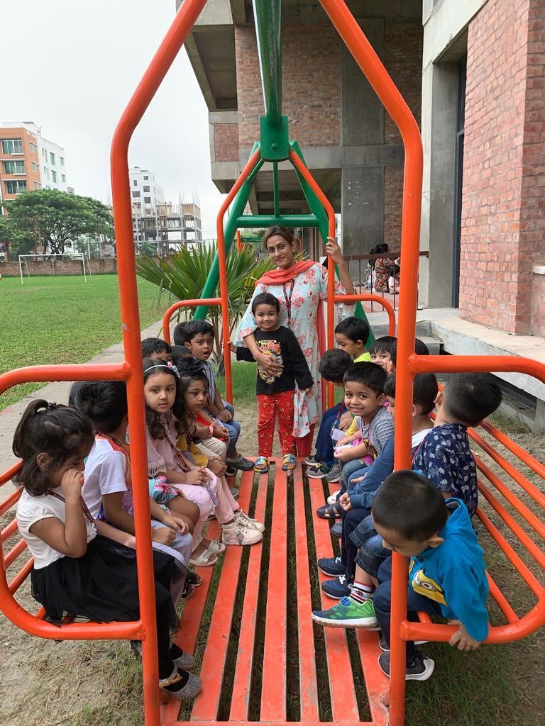 Playpen’s youngest pupils on the playground with their teacher