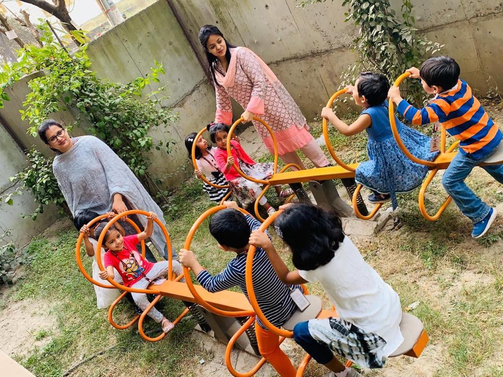 Playpen teachers with young pupils on the playground